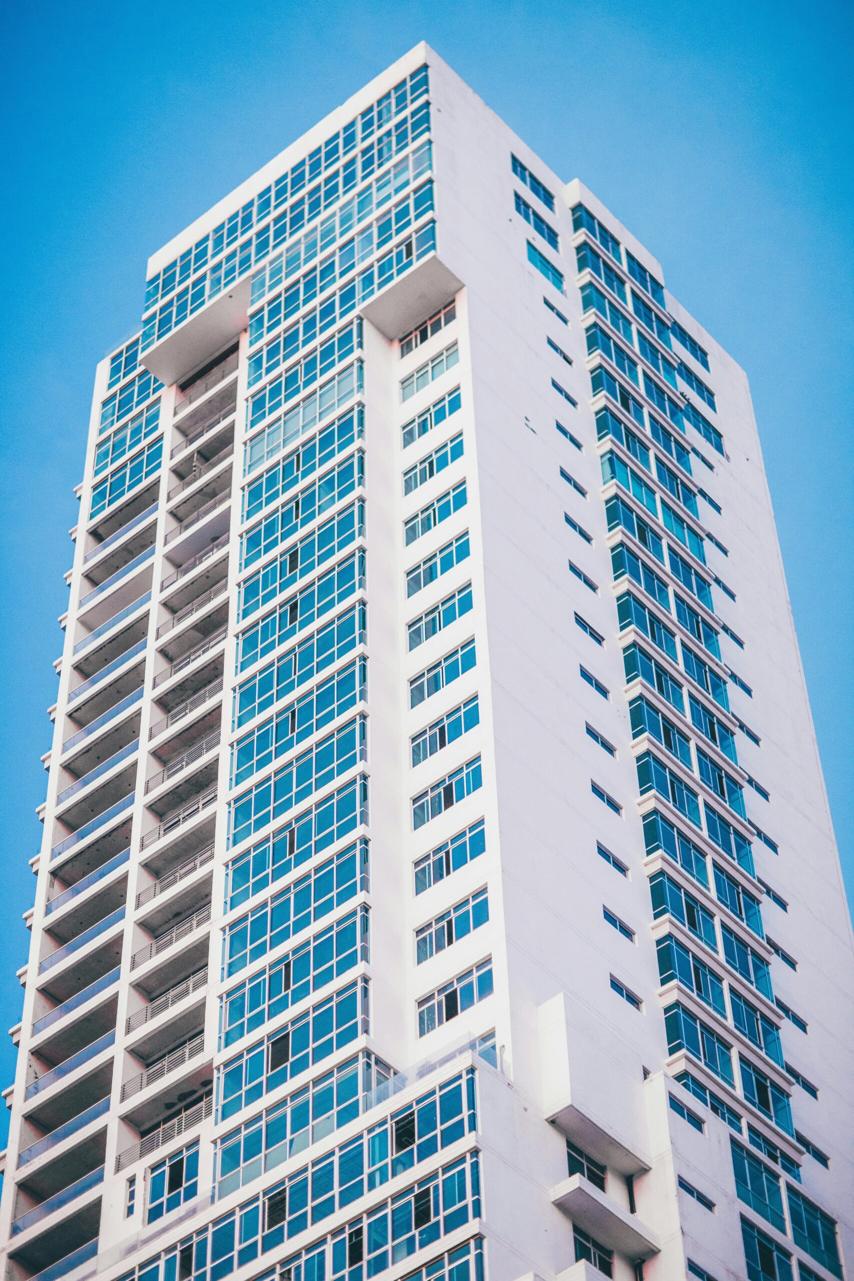 Stunning view of a modern skyscraper with a glass facade captured from a low angle on a clear day.